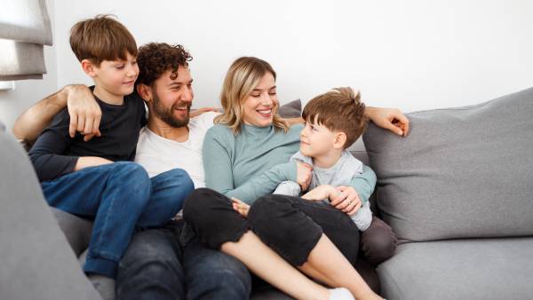 family-on-couch Family of four sitting on couch together